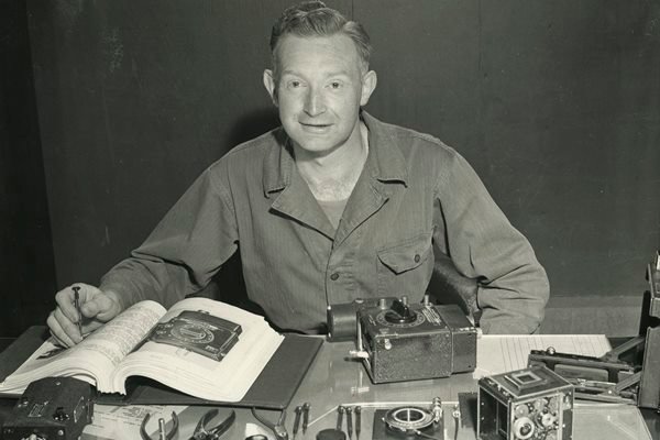 Adolph Gasser sitting at a desk