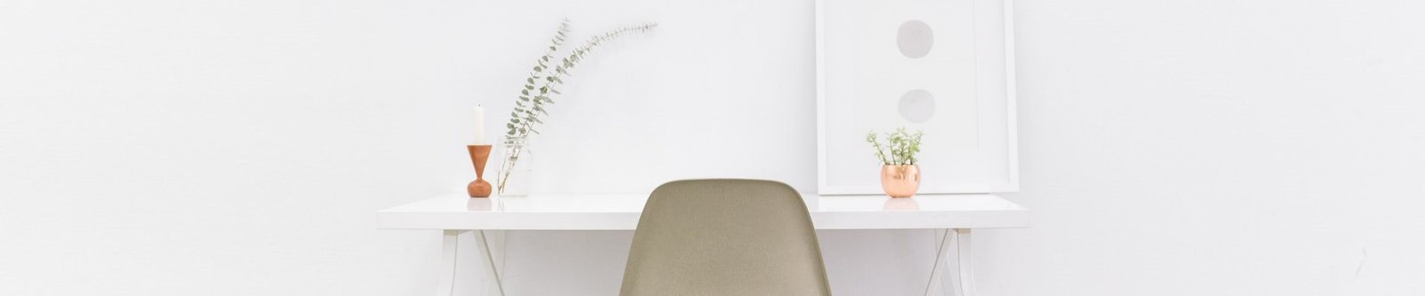 A white chair and desk in front of a wall