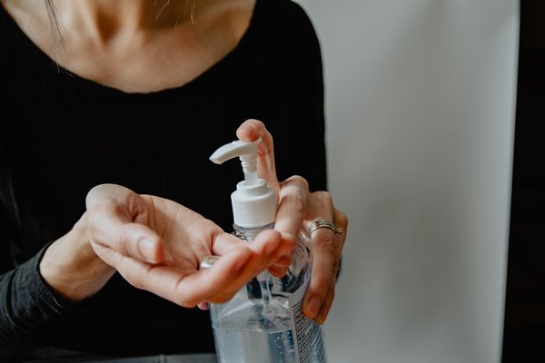 Woman using hand sanitizer