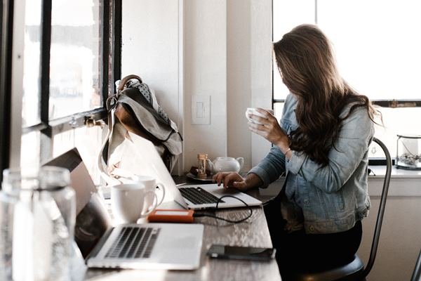 A woman sitting down, working