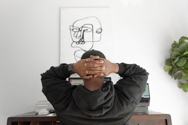 Man at a desk with his hands on his head